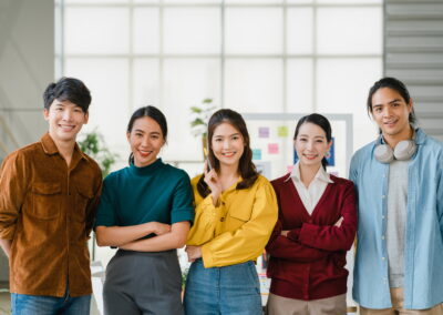 Group of Asia young creative people in smart casual wear smiling